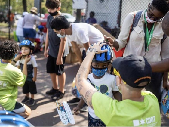 Kids being fitted for bicycle helmets